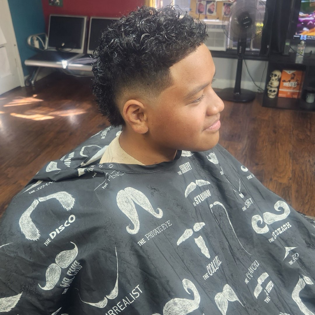Men's textured curly top with a skin fade at Sees Barbershop in Concord, CA