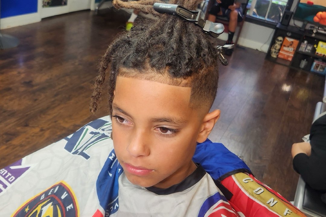 Kid's haircut with locs and a tapered fade at Sees Barbershop, Concord, CA